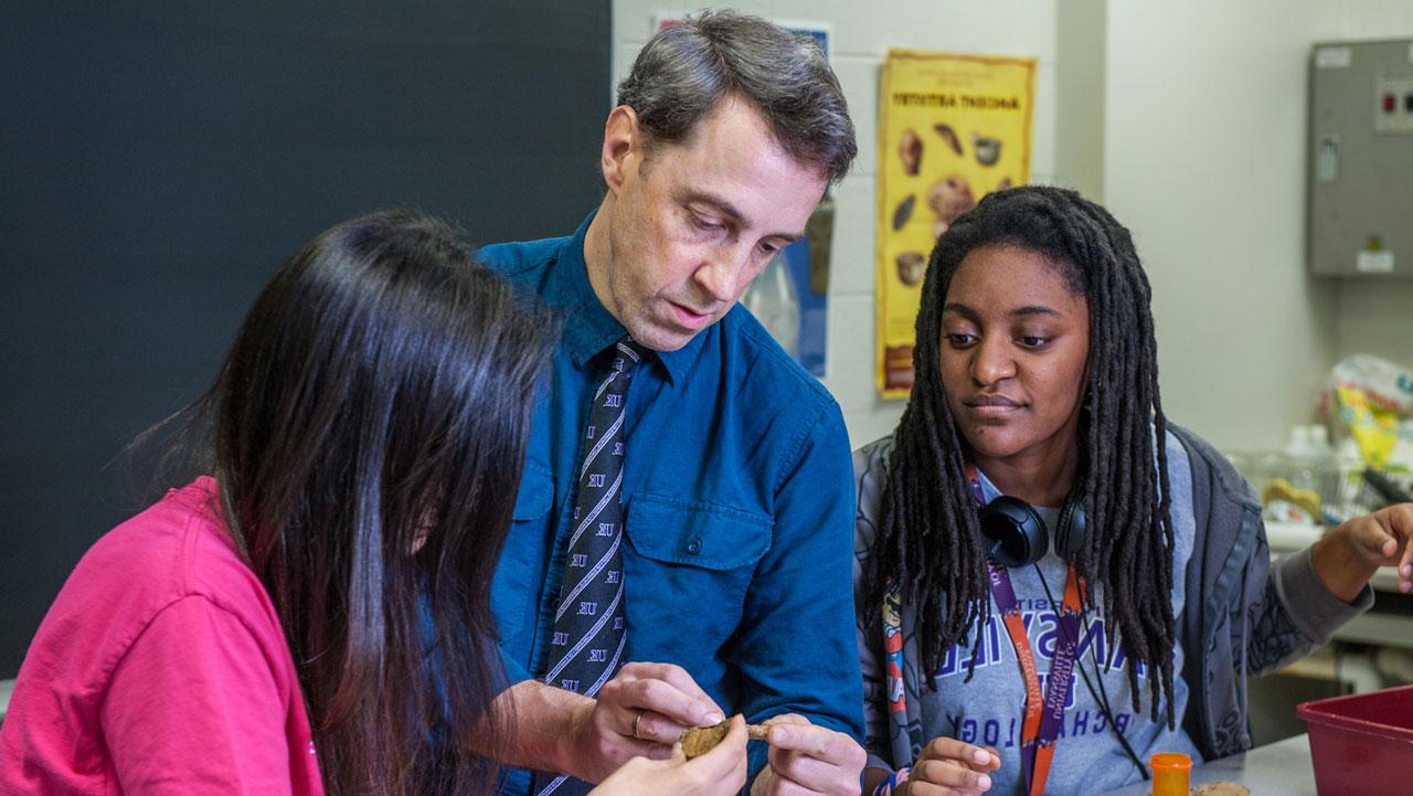 UE faculty Alan Kaiser in instructing two archaeology students